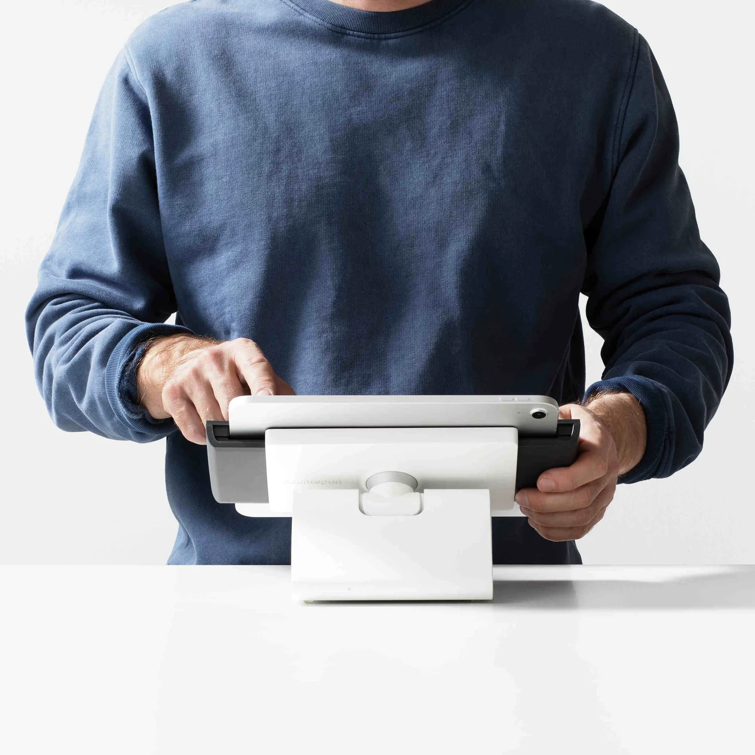 The original Bouncepad Clip Flip tablet stand held by a staff member
